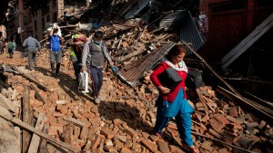 Nepalese residents carry belongings from their destroyed homes as they walk through debris of Saturday's earthquake, in Bhaktapur on the outskirts of Kathmandu, Nepal, Monday, April 27, 2015. A strong magnitude earthquake shook Nepal’s capital and the densely populated Kathmandu valley on Saturday devastating the region and leaving tens of thousands shell-shocked and sleeping in streets. (AP Photo/Niranjan Shrestha)