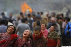 Family members break down during the cremation of earthquake victims in Bhaktapur near Kathmandu, Nepal, Sunday, April 26, 2015. A strong magnitude 7.8 earthquake shook Nepal's capital and the densely populated Kathmandu Valley before noon Saturday, causing extensive damage with toppled walls and collapsed buildings, officials said. (AP Photo/Niranjan Shrestha)